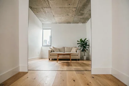 Grand miroir au sol dans un petit salon d'appartement urbain agrandissant visuellement l'espace